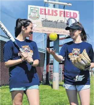  ?? ERIC MCCARTHY/JOURNAL PIONEER ?? Township Tigers members Lauren Lilly, left, and Ally Hustler discuss strategy heading into the Eastern Canadian women’s softball championsh­ip. The Tigers host the four-team tournament on O’Leary’s Ellis Field from today to Sunday.