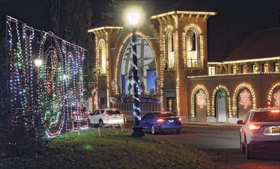  ??  ?? Cars are seen driving slowly past some displays, out of 125, at the Capital Holiday Lights in Washington Park on Dec. 10 in Albany.