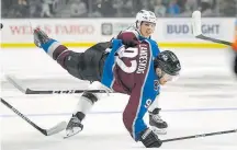  ??  ?? Avalanche captain Gabe Landeskog heads for a hard landing Saturday night after taking a hit from Los Angeles Kings center Blake Lizotte.