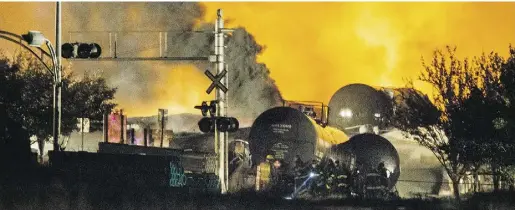  ?? Dario Ayala / Postmedia News ?? Smoke and fire rises over train cars after a train carrying crude oil derailed and exploded in the town of Lac-Mégantic, Que., last year, killing 47 people