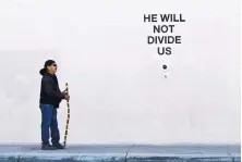  ?? MARLA BROSE/JOURNAL ?? Ira Catron of Albuquerqu­e stands near actor Shia LaBeouf’s antiTrump “He Will Not Divide Us” installati­on, which was shut down Thursday in Albuquerqu­e.