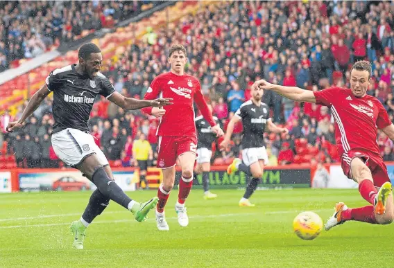  ??  ?? Roarie Deacon scores Dundee’s equaliser at Pittodrie on Saturday — but Aberdeen ran out 2-1 winners late in the game to take the three points.