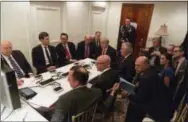  ?? THE ASSOCIATED PRESS ?? In this image provided by the White House, President Donald Trump receives a briefing on the Syria military strike Thursday night from his National Security team after the strike at Mar-a-Lago in Palm Beach, Fla.