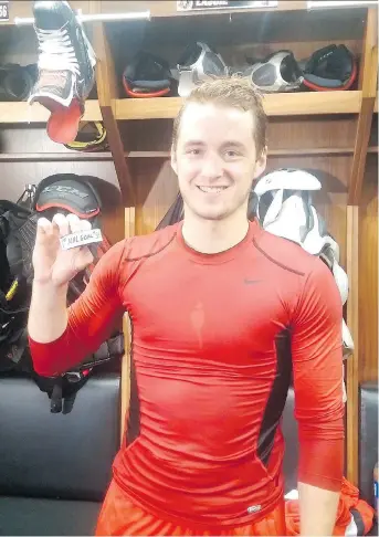  ?? BRUCE GARRIOCH ?? Senators rookie defenceman Max Lajoie holds the puck from his first NHL goal on Oct. 4. In town, Lajoie is staying at the home of veteran goaltender Craig Anderson.