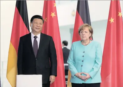  ?? PHOTO: BLOOMBERG ?? Xi Jinping, China’s President, left, and Angela Merkel, Germany’s chancellor, look on during a contract-signing ceremony at the chanceller­y in Berlin, Germany, last week. Xi and Merkel called for expanded trade between the two nations, taking a joint...