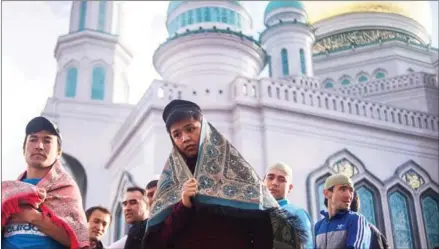  ?? ALEXANDER UTKIN/AFP ?? Russian Muslims pray outside the central mosque in Moscow on July 5 during celebratio­ns of Eid al-Fitr marking the end of the fasting month of Ramadan.