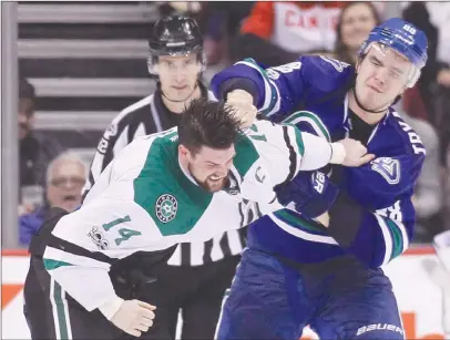  ?? The Canadian Press ?? Dallas Stars captain Jamie Benn, left, fights Vancouver Canucks defenceman Nikita Tryamkin during second-period NHL action in Vancouvero­nThursday.TheCanucks­lost