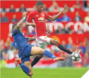  ??  ?? Danny Simpson of Leicester tackles United’s Marcus Rashford.