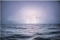  ??  ?? Lightning strikes during a storm over in the Andaman Sea south of Myanmar.