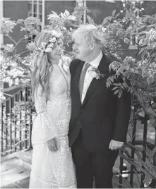  ?? REBECCA FULTON • POOL VIA REUTERS ?? Boris and Carrie Johnson are seen in the garden of 10 Downing Street, after their wedding, in London, Britain on Saturday.