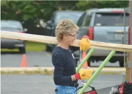  ?? ?? Julie McDermid, of Homer Glen, helps construct elements of a house for Habitat for Humanity at a volunteer effort last weekend in Tinley Park. She said she has experience building houses as she helped restore a damaged home in the Florida Keys after Hurricane Irma.