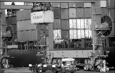  ?? AP ?? A worker watches loading and unloading of cargo containers at a port in Tokyo. Japan had the second straight year of red ink in trade in 2019, hurt by a slowdown of demand in China, according to government data released Thursday.