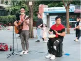  ??  ?? Licensed buskers perform at Jing’an Park. — Wang Rongjiang