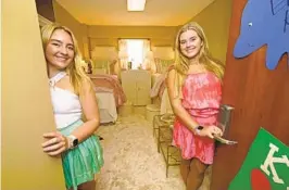  ?? ROGELIO V. SOLIS AP PHOTOS ?? Childhood friends Sydney Allbritton, 18, (left) and Emma Kirk, 19, pose in their decorated dorm room at the University of Mississipp­i, in Oxford. Students who can afford it are spending big bucks to decorate their rooms, adding yet another layer to the soaring costs of college.