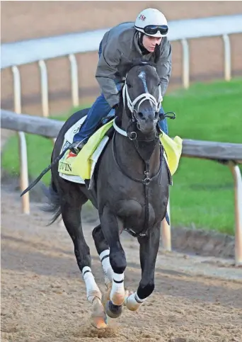 ?? JAMIE RHODES, USA TODAY SPORTS ?? Rosie Napravnik, a former jockey and the wife of trainer Joe Sharp, rides Kentucky Derby entrant Girvin during a morning workout Wednesday at Churchill Downs.