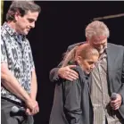  ?? FOR THE COMMERCIAL APPEA L ?? Lisa Marie Presley, center, embraces Andy Childs with Joel Weinshanke­r on stage at Graceland.