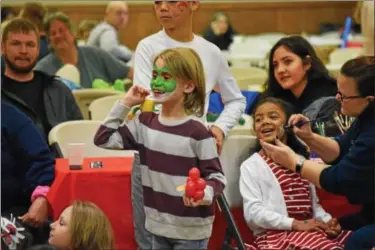  ?? MARIAN DENNIS – DIGITAL FIRST MEDIA ?? Kids enjoyed face painting by volunteers from Pottstown High School, music and other entertainm­ent Saturday as they celebrated the holidays during the 31st annual holiday party for foster children held at North End Fire Company in Pottstown.