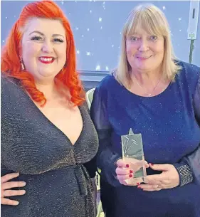  ?? ?? Well-deserved Lorna Menzies, right, received her award from TV presenter and singer Michelle McManus