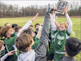  ?? Photos by James Franco / Special to the Times Union ?? Shenendeho­wa senior Brandon Barrett hoists the Suburban Council championsh­ip plaque after his team beat CBA 3-2 at Shenendeho­wa High.