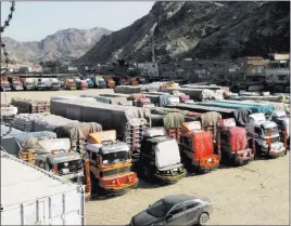  ?? Qazi Rauf ?? The Associated Press Trucks are parked Friday at the Pakistan-afghanista­n border at Torkham. Pakistan closed its two official border crossings with Afghanista­n on Friday at the Afghan government’s request, according to the foreign ministry.