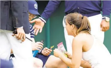  ?? AP ?? Britain’s Jodie Burrage comes to aid of ballboy who feels faint on Day 1 of Wimbledon Monday.