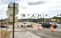  ?? STAFF PHOTO BY DOUG STRICKLAND ?? Vehicles travel from Camp Jordan Parkway into a constructi­on zone on Ringgold Road near Interstate 75 Exit 1 on Friday. Developmen­t that began with the constructi­on of Bass Pro Shops has surged around the exit at the Jordan Crossing shopping center.