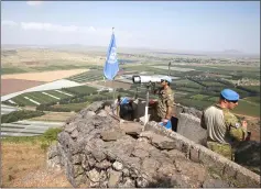  ??  ?? A United Nations Truce Supervisio­n Organisati­on military observer uses binoculars near the border with Syria in the Israeli-occupied Golan Heights, Israel. — Reuters photo