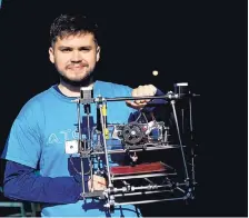  ?? NATACHA PISARENKO/ASSOCIATED PRESS ?? Gino Tubaro holds the first 3D printer he invented. Hundreds of Argentine kids born without limbs are using low-cost 3D prosthetic arms and legs created by Tubaro.