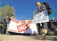  ?? MARK J. TERRILL AP ?? A group protests in Los Angeles outside the headquarte­rs of the regulatory body for domain names, the Internet Corporatio­n for Assigned Names and Numbers. Critics say a takeover of the dot-org domainsett­ing registry would lead to price gouging and censorship.