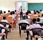  ?? ?? YEP, Director G C Mendis addressing school children at Pinnawala Central College.