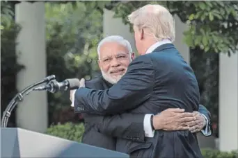  ?? JABIN BOTSFORD THE WASHINGTON POST ?? President Donald Trump and Indian Prime Minister Narendra Modi's Rose Garden hug surprised onlookers.