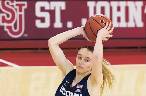  ?? Kathy Willens / Associated Press ?? Connecticu­t guard Paige Bueckers (5) looks to pass as she keeps the ball from a St. John’s’ defender on Wednesday.