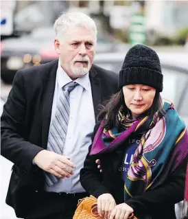  ?? DARRYL DYCK / THE CANADIAN PRESS ?? Huawei chief financial officer Meng Wanzhou arrives at a parole office with a security guard in Vancouver on Wednesday, after being released on $10 million bail Tuesday.