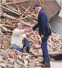  ?? ANDREW HARNIK/ASSOCIATED PRESS ?? President Joe Biden meets a resident Wednesday as he surveys storm damage from tornadoes in Mayfield, Ky.