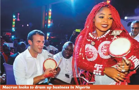  ?? AP ?? French President Emmanuel Macron (left), performs with a drum at the New Afrika Shrine in Lagos, Nigeria. Macron has arrived in Nigeria in his latest attempt to forge closer ties with English-speaking Africa.