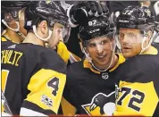  ?? GENE J. PUSKAR — ASSOCIATED PRESS ?? The Penguins’ Sidney Crosby celebrates his goal with teammates Patric Hornqvist (72) and Justin Schultz (4).