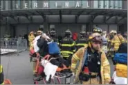  ?? MARK LENNIHAN — THE ASSOCIATED PRESS FILE PHOTO ?? An injured passenger is taken from the Atlantic Terminal in Brooklyn after a Long Island Rail Road train hit a bumping block. Federal investigat­ors have found that the engineers of two New York City-area commuter trains that crashed into stations were...