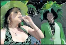  ?? POSTMEDIA NETWORK ?? Lona Bronee ( L) and her husband Matt smoke a joint of marijuana in front of Calgary City Hall as they join dozens of other Calgarians at the 4\ 20 rally to call for the legalizati­on of Marijuana.