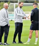  ??  ?? Guidance: Gareth Southgate (centre) and Les Reed (left) talk to Mason Mount