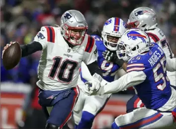  ?? Associated Press ?? Defensive end Jerry Hughes pressures Patriots quarterbac­k Mac Jones in the first half of the Bills’ 47-17 win Saturday. Hughes said he felt the defense went in with something to prove.