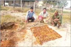  ?? SUPPLIED ?? Authoritie­s pose for a photograph with more than 100 unexploded mortar rounds unearthed at a school in Pursat over the weekend.