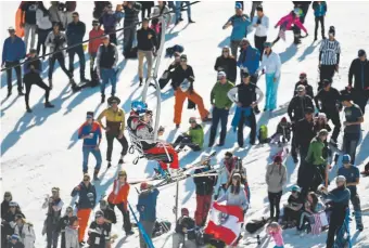  ?? Helen H. Richardson, Denver Post file ?? Fans gather on the hillside and watch from the chairlift as they cheer on skiers taking part in the World Cup Slalom race on Aspen Mountain on March 18, 2017.
