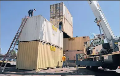  ?? EDDIE MOORE/JOURNAL ?? Use your imaginatio­n, and these shipping containers represent multistory buildings on St. Michael’s Drive that could house cafes, bars and lofts. The faux buildings went up Thursday as part of Re:MIke, a weekend festival intended to spur ideas for...