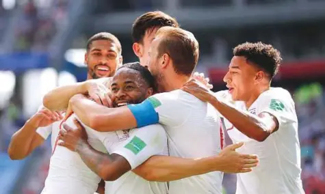  ?? AP ?? England’s John Stones is congratula­ted by teammates after scoring his team’s fourth goal during the Group G match against Panama at the Nizhny Novgorod Stadium on Sunday. England won 6-1.