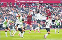  ?? ?? Indefensib­le: Liverpool are static as Jarrod Bowen rises to score West Ham’s opener; (below) Jurgen Klopp and Mohamed Salah clash on the touchline at the London Stadium