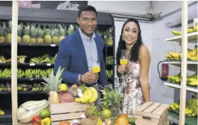  ?? ?? Jamaica Observer Table Talk Food Awards judges Oneal Johnson and Mala Morrison sipped Prosecco while checking out the S Foods fresh produce stand.