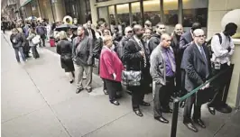  ?? BEBETO MATTHEWS/AP ?? Job seekers wait at a job fair in New York. But many discourage­d Americans are giving up the job hunt in exchange for school, retirement and disability.