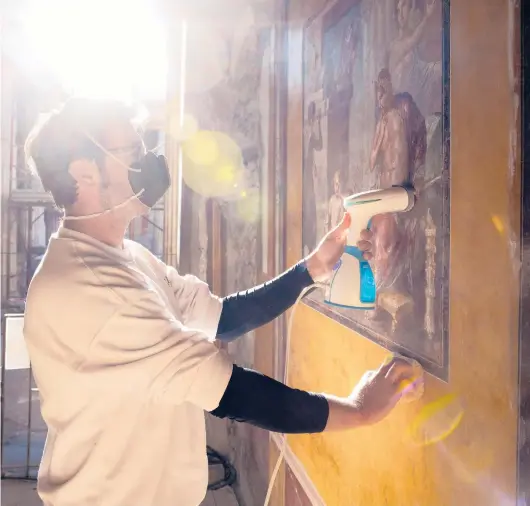  ?? ROBERTO SALOMONE/THE NEW YORK TIMES PHOTOS ?? Ignazio Carlo Raucci, a restorer, uses steam to clean one of the frescoes inside the House of the Vettii on Feb. 23 in Pompeii, Italy.