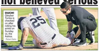  ?? Robert Sabo ?? OUCH! Gleyber Torres is checked on after rolling his ankle on Sunday vs. the Astros.
