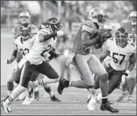  ?? AP/RICK OSENTOSKI ?? Detroit Lions wide receiver Calvin Johnson (81) pulls away from the Chicago Bears defense during the second half of Thursday’s game in Detroit. Johnson, who was held under 60 yards twice since returning from an ankle injury, had 146 yards and two...